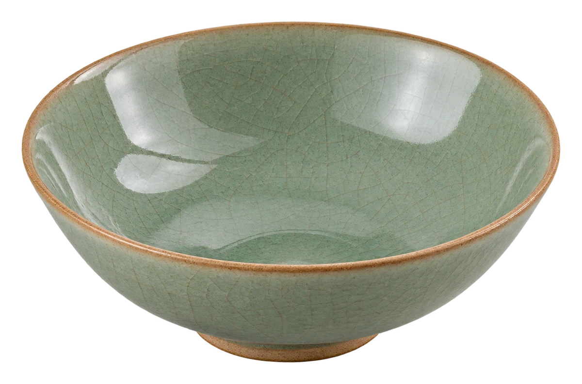 Pale green ceramic bowl with crackled glaze and a brown rim, isolated on a transparent background.